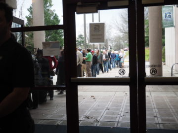 picture of customers waiting in line to sign in at the Greenville public hearing